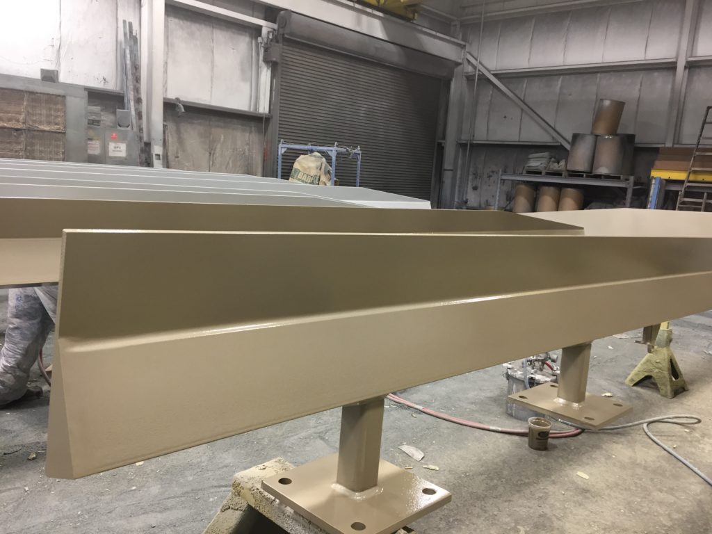 a photo of the side view of a structural beam with beige ambient cured fluoropolymer coating