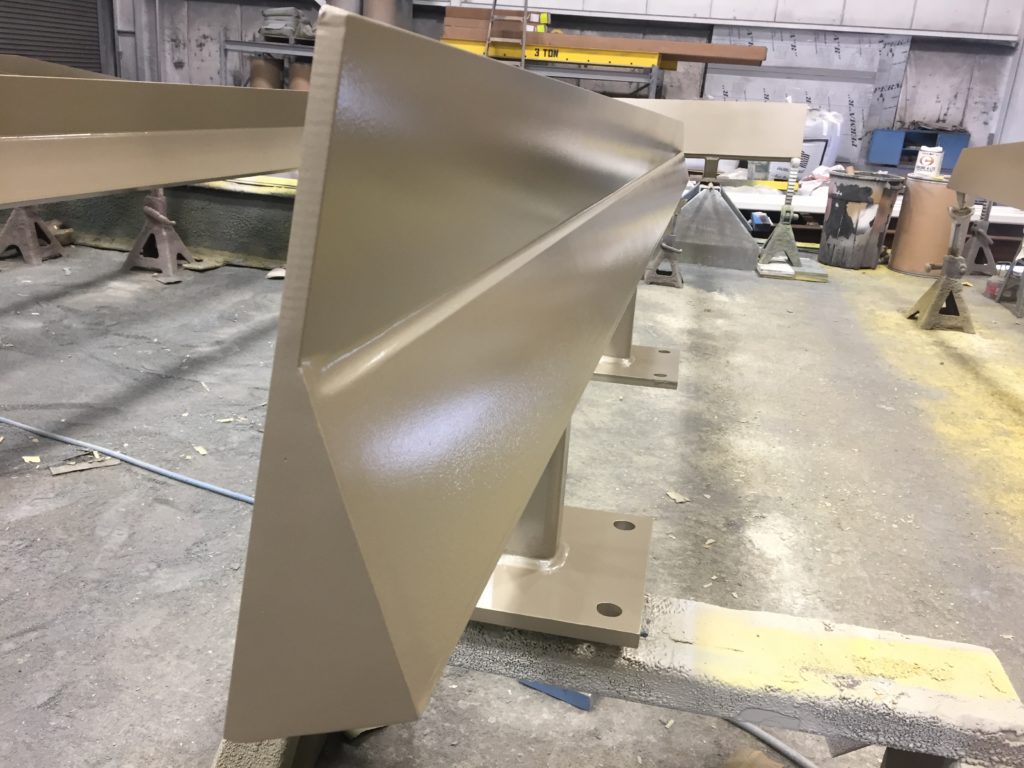 a photo of the end profile of a structural beam with beige ambient cured fluoropolymer coating