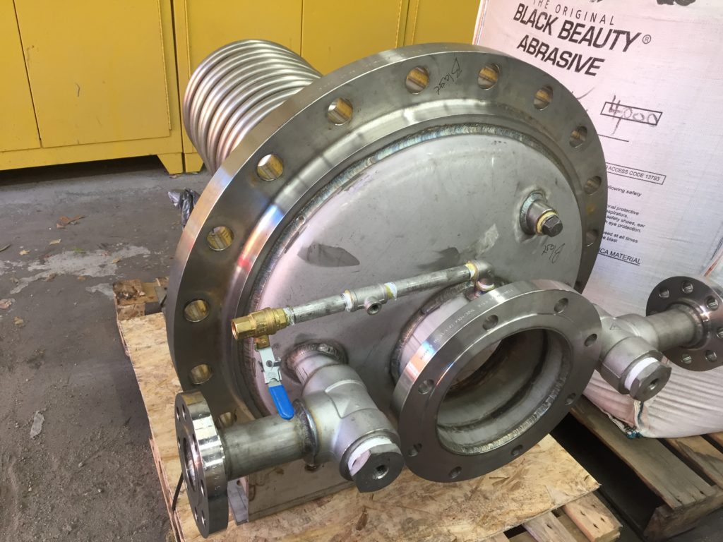 a large stainless steel valve marked in preparation for blasting with glass bead media